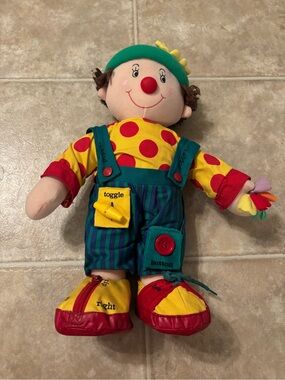 1990s vintage “chuckling Chester” learn to dress clown doll.